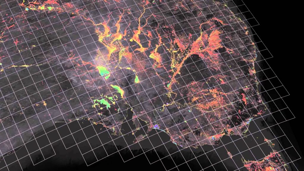 Satellite composite map with glowing network lines overlaid on a dark grid