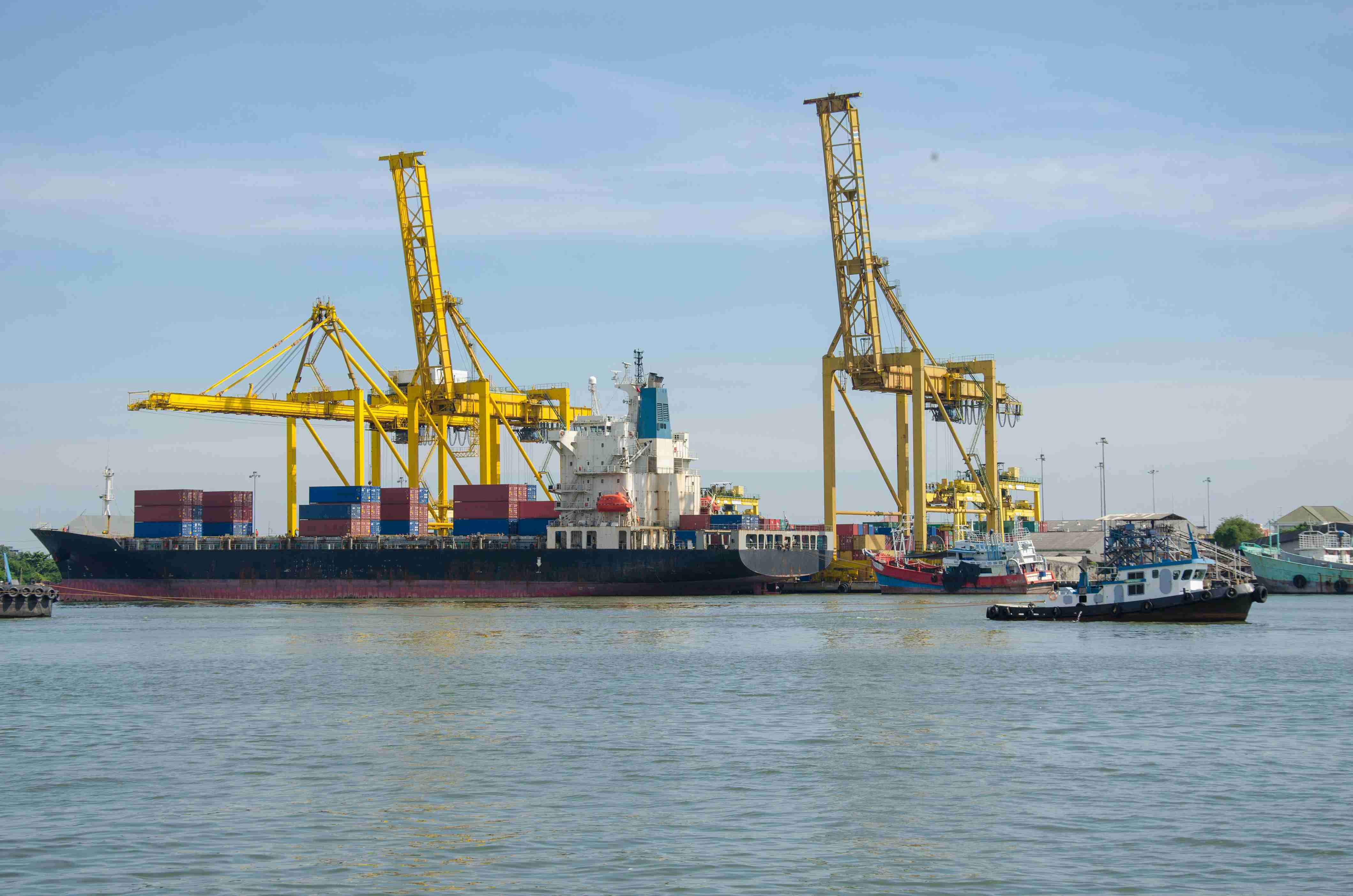 Cargo ship docked near yellow cranes